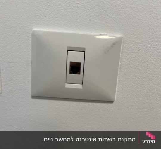 נקודת רשת תקשורת בודדת מותקנת על קיר לבן
